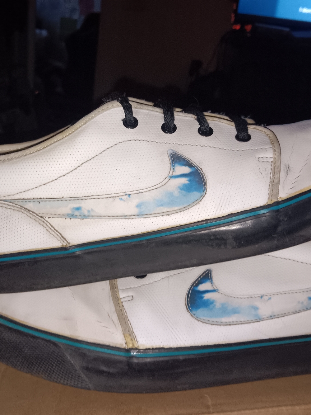 Nike White Low-Top Sneakers with Blue Swoosh and Black Soles